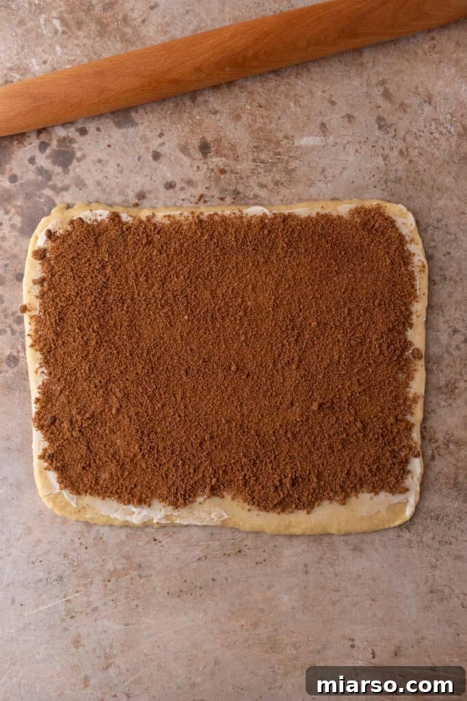 Perfect Small Batch Cinnamon Rolls 9 Rolled-out dough covered generously with brown sugar and cinnamon filling.