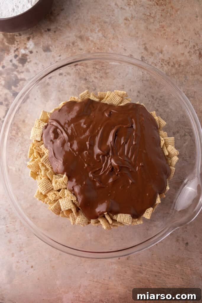 Irresistible Muddy Buddy Bars 8 unmixed ingredients in a bowl
