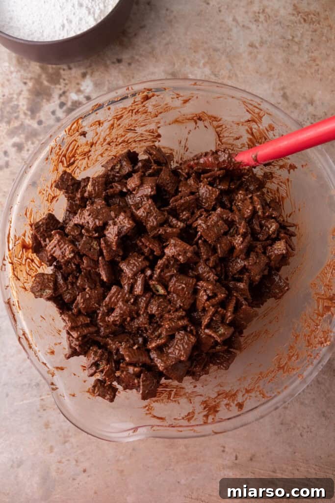 Irresistible Muddy Buddy Bars 9 mixed ingredients in a bowl