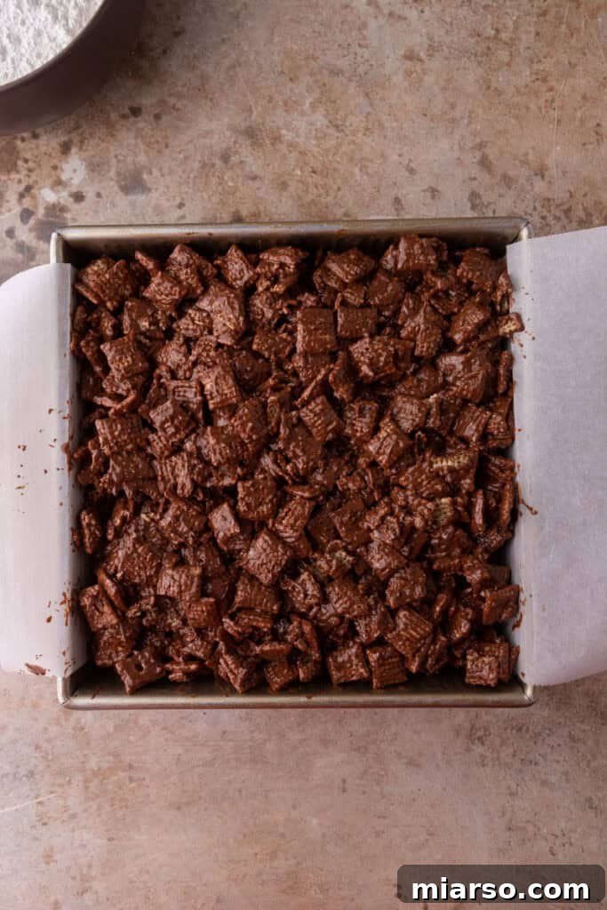 Irresistible Muddy Buddy Bars 10 ingredients in a pan