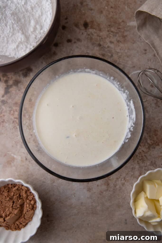 Heavy cream warming in a saucepan, ready to be poured over chocolate for ganache.