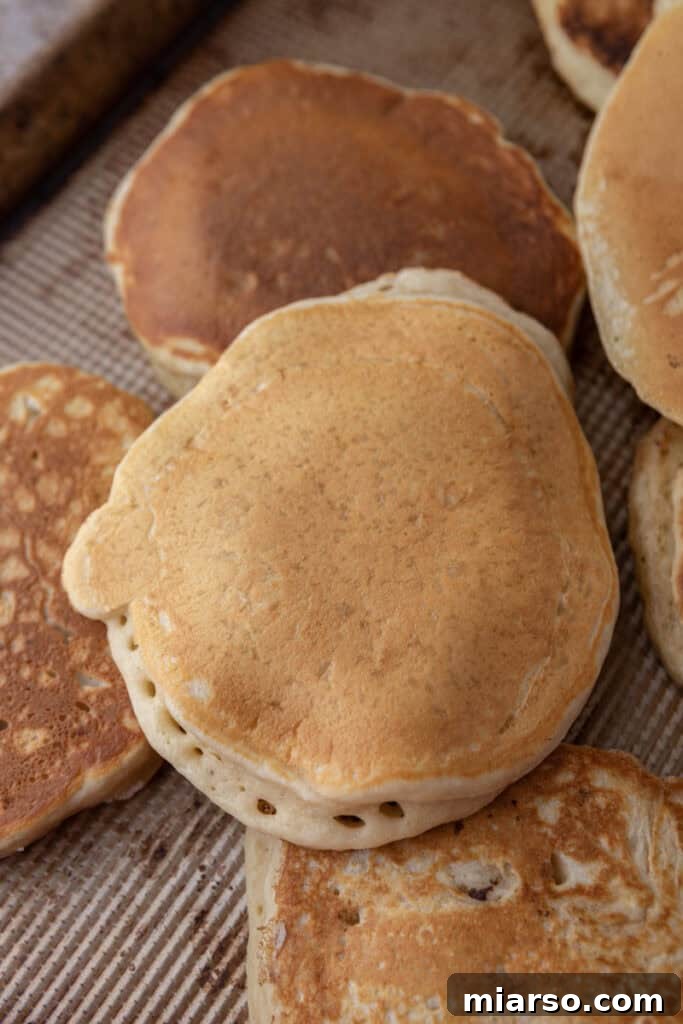 Freshly cooked sourdough discard pancakes stacked on a plate