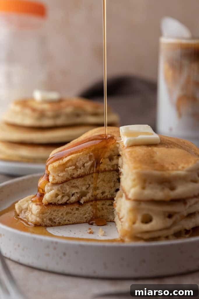 A stack of golden brown sourdough discard pancakes with toppings