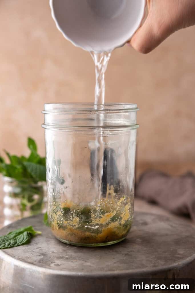 DIY Phylz Mint Mojito Iced Coffee 7 Hand pouring hot water in a cup