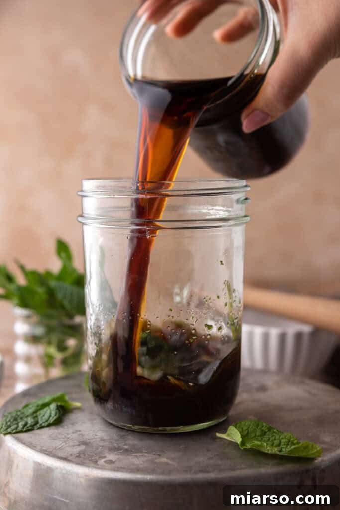 DIY Phylz Mint Mojito Iced Coffee 8 Hand pouring cold brew coffee in a cup