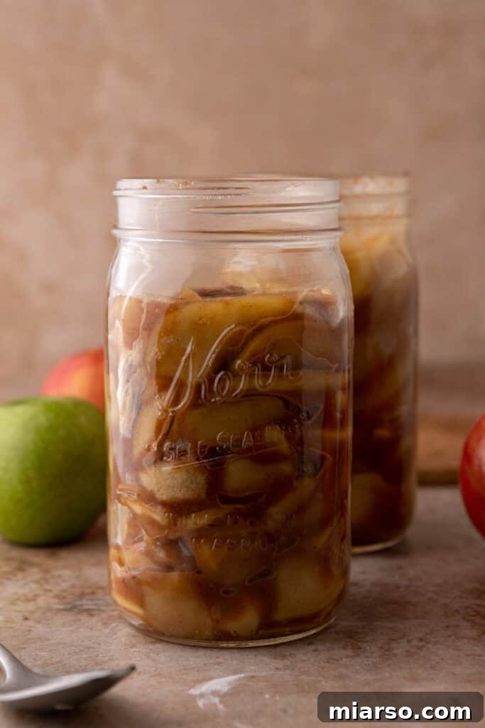 Effortless Apple Filling for Delicious Desserts 4 A glass jar filled with the perfectly cooked homemade apple pie filling, ready for use.