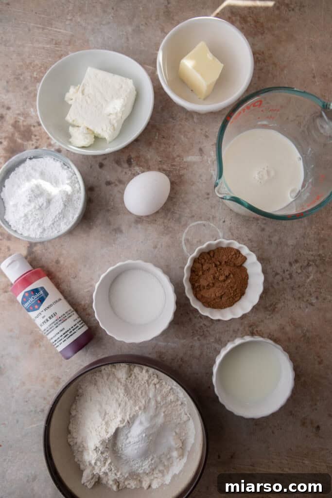 Indulgent Red Velvet Pancakes 3 A collection of fresh Red Velvet Pancakes Recipe ingredients laid out on a kitchen counter, showcasing flour, cocoa, eggs, buttermilk, and butter.