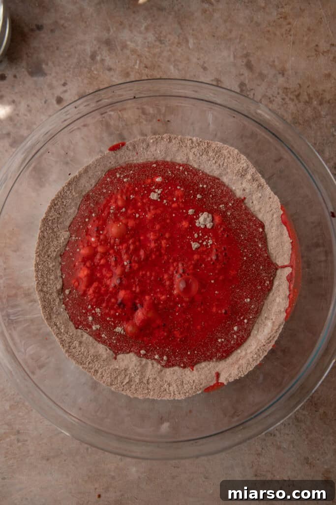Indulgent Red Velvet Pancakes 6 Wet ingredients for Red Velvet Pancakes mixed smoothly in a separate bowl, showcasing the vibrant red food coloring.
