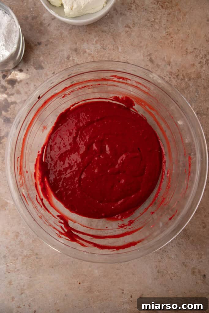 Indulgent Red Velvet Pancakes 7 Red Velvet Pancake batter after wet and dry ingredients are combined, showing the distinct red hue and a few small lumps.
