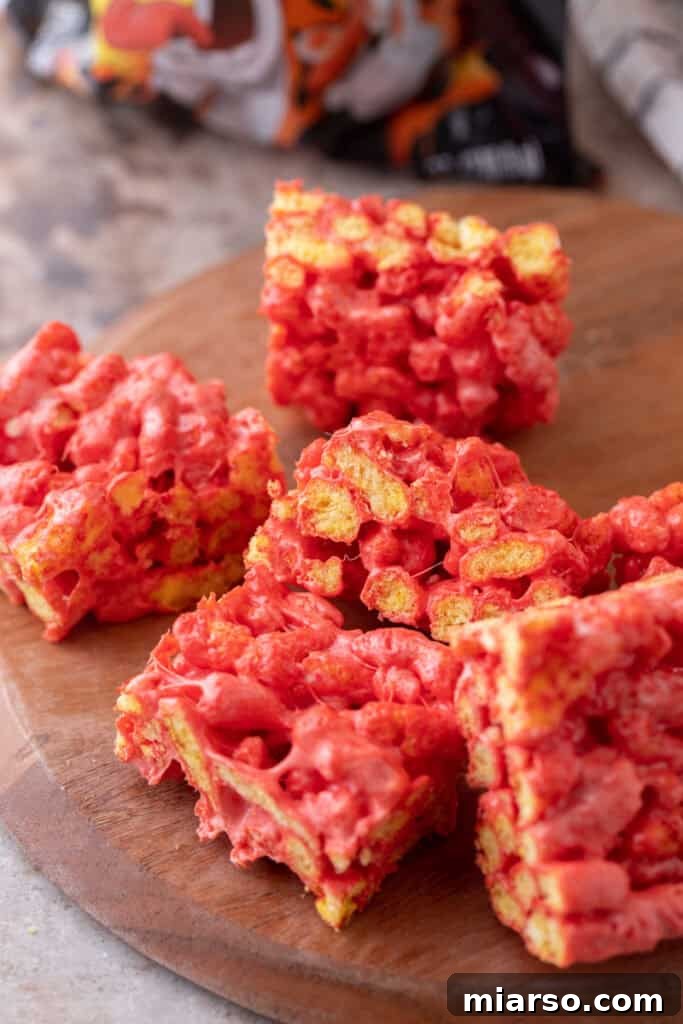 Overhead shot of Hot Cheetos Marshmallow Crispy Treats arranged on a platter.