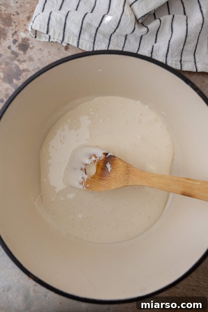 Mini marshmallows added to melted butter in a pot.