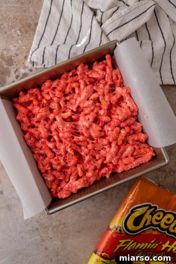 The Hot Cheetos and marshmallow mixture pressed into a baking pan.