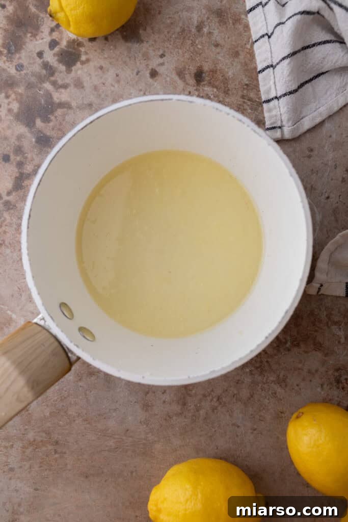 Lemon juice and sugar warming in a saucepan