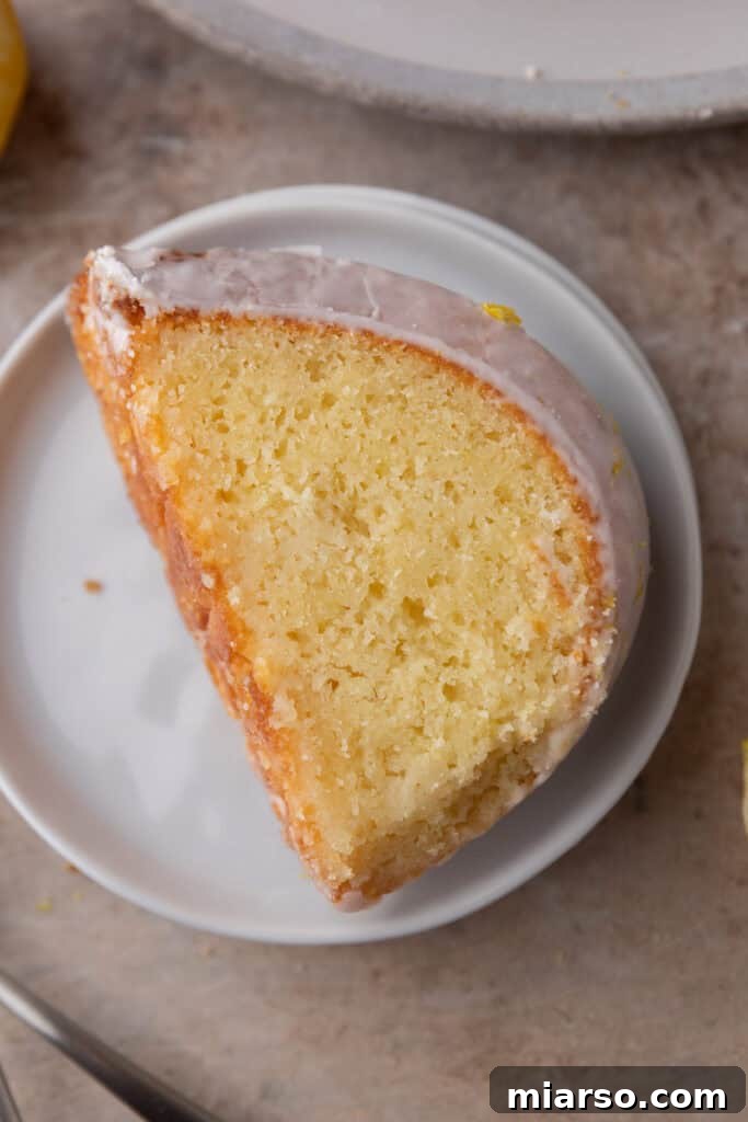 A closer look at a slice of the lemon bundt cake, showing the texture and glaze.