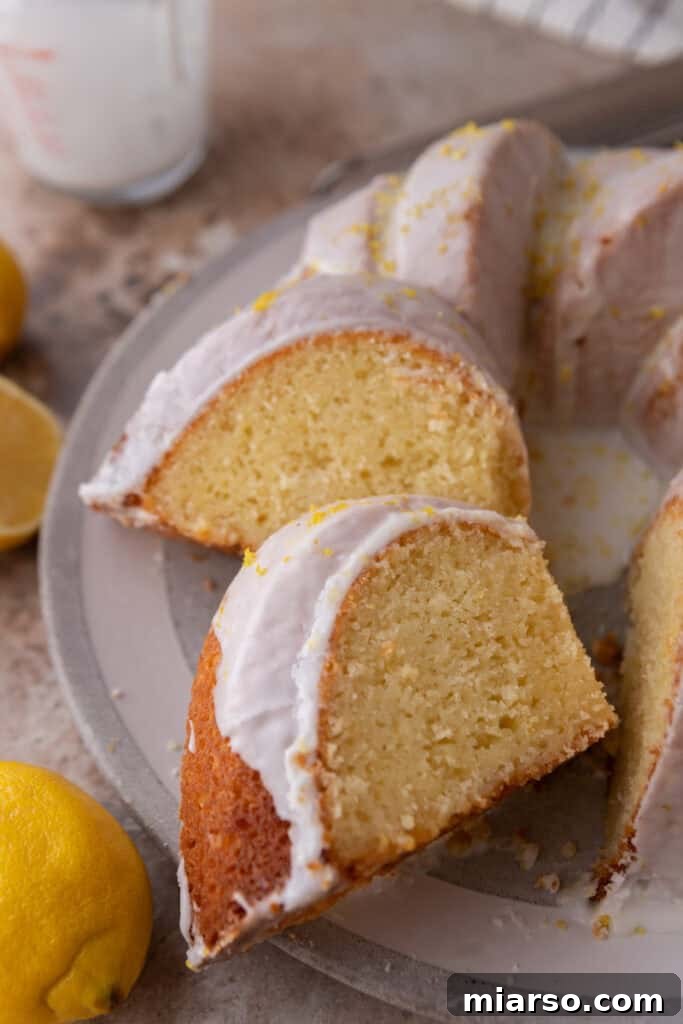 Three perfectly cut slices of the moist lemon bundt cake, arranged beautifully on a plate.