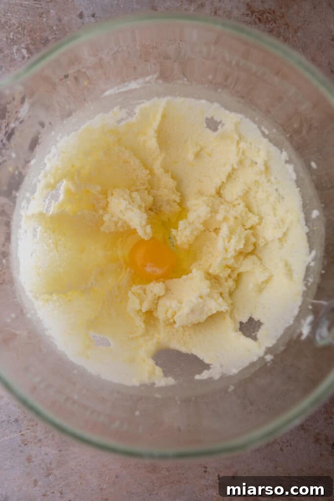 Softened butter added to sugar and lemon zest