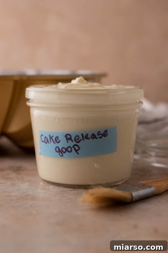 Close-up side view of homemade cake release in a jar, showcasing its smooth texture.