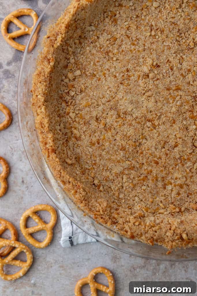 Ultimate Pretzel Pie Crust 2 Overhead shot of a finished Pretzel Pie Crust, golden brown and perfectly set in a pie dish.