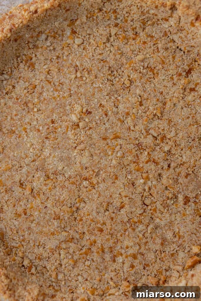 Ultimate Pretzel Pie Crust 4 Close-up of the mixed pretzel pie crust ingredients in a bowl, ready to be pressed.