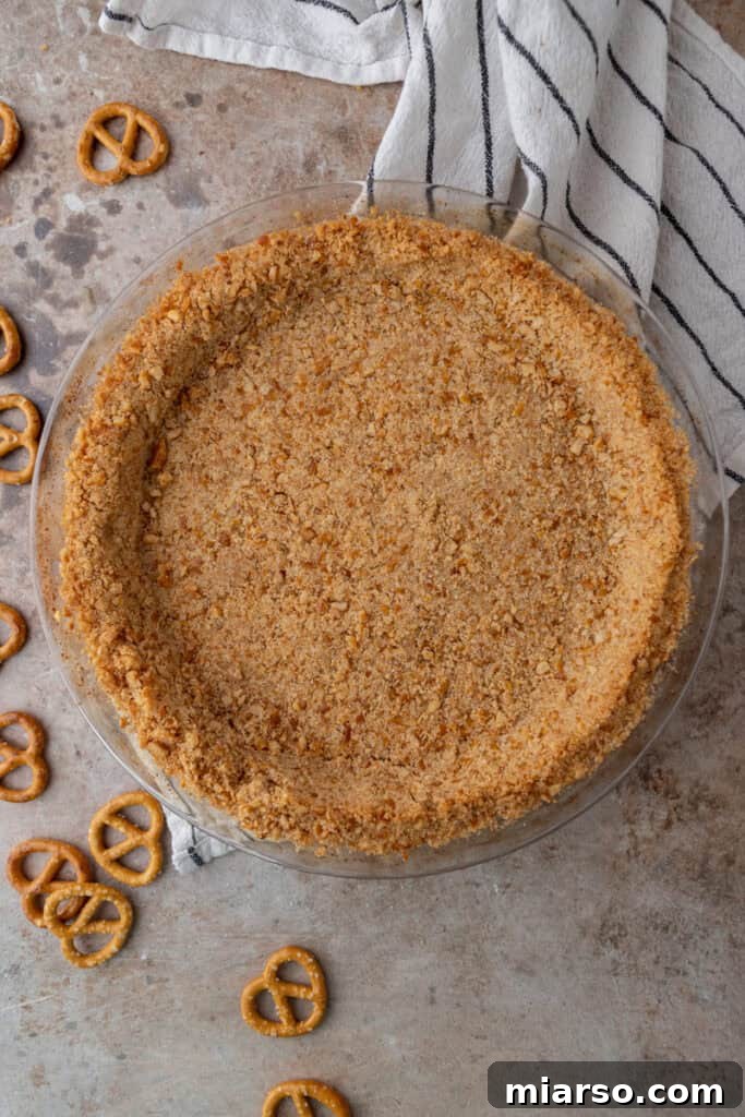 Ultimate Pretzel Pie Crust 9 Baked pretzel pie crust cooling in a pie pan.