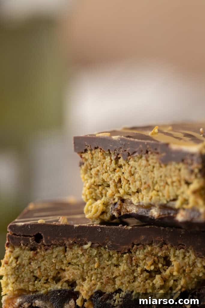 Several pieces of Dubai Chocolate Date Bark stacked, showing the layered structure and rich colors.