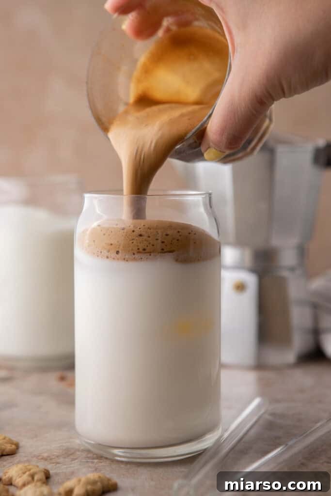 coffee mixture being poured over milk