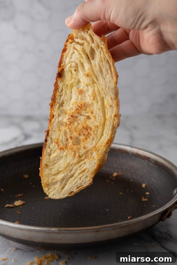 Elevate Your Baking Perfect Sourdough Croissant Bread 2 a slice of the Croissant Sourdough Bread Recipe being toasted