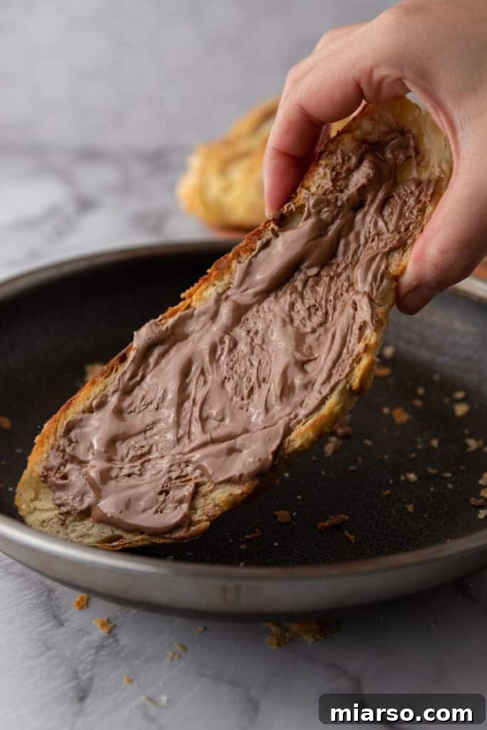 Elevate Your Baking Perfect Sourdough Croissant Bread 24 a slice of the Croissant Sourdough Bread Recipe being toasted