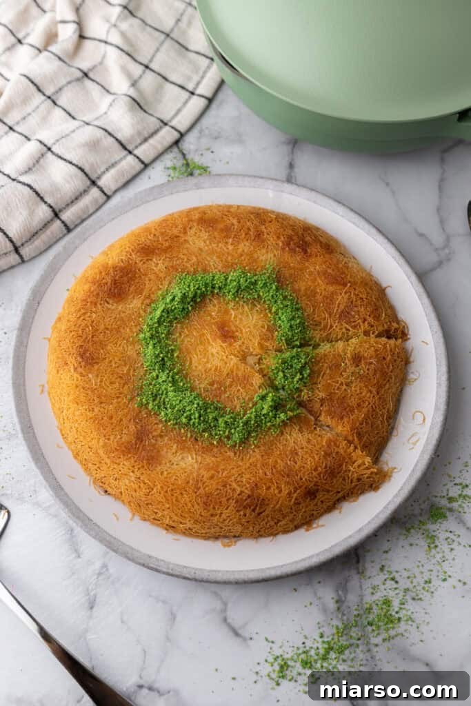 cooked dough and cheese circle on a plate with pistachio garnish