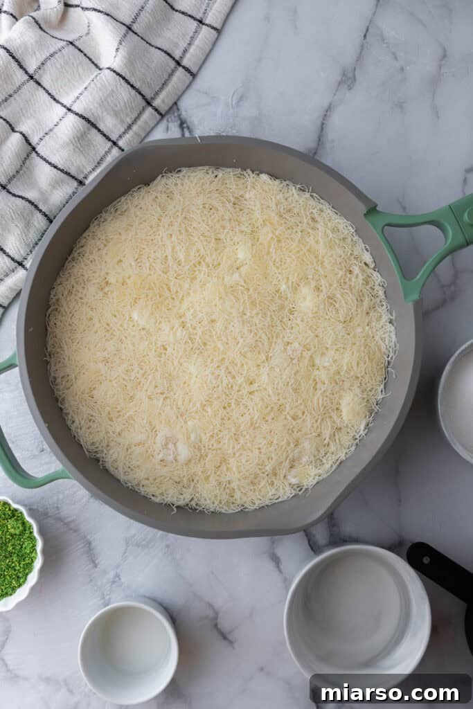 dough and cheese in a pan pressed down