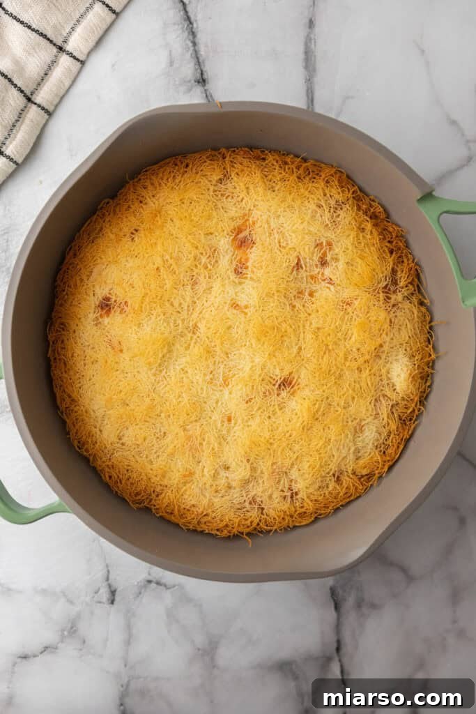 cooked dough and cheese in a pan pressed down