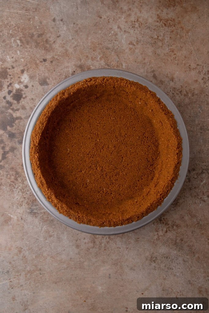 The Secret to a Perfect Biscoff Pie Crust 10 ingredients being pressed into a pan