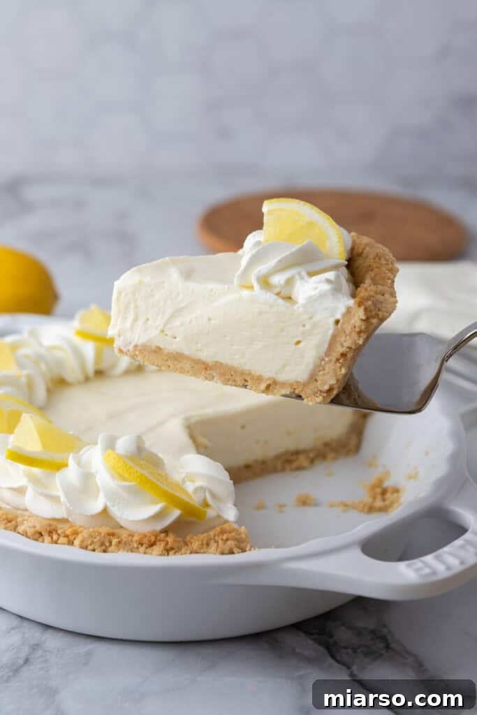 Zesty No Bake Lemon Pie Perfection 4 slice of the no bake lemon pie being held up