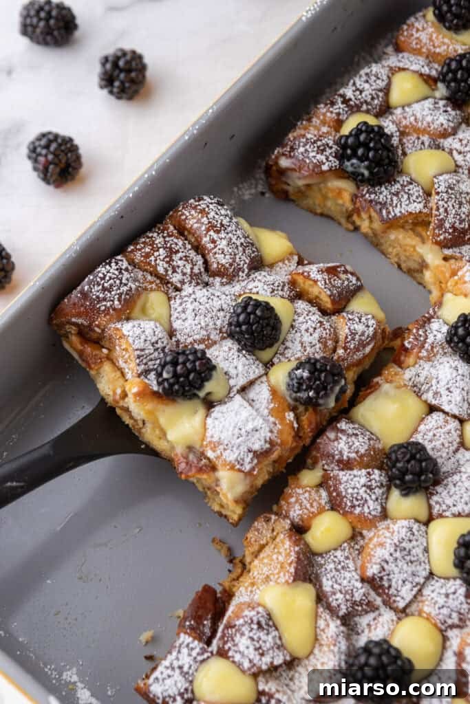A captivating image of a perfectly cooked slice of Pretzel French Toast Bake being carefully lifted out of the baking pan with a serving spatula, ready for its presentation.