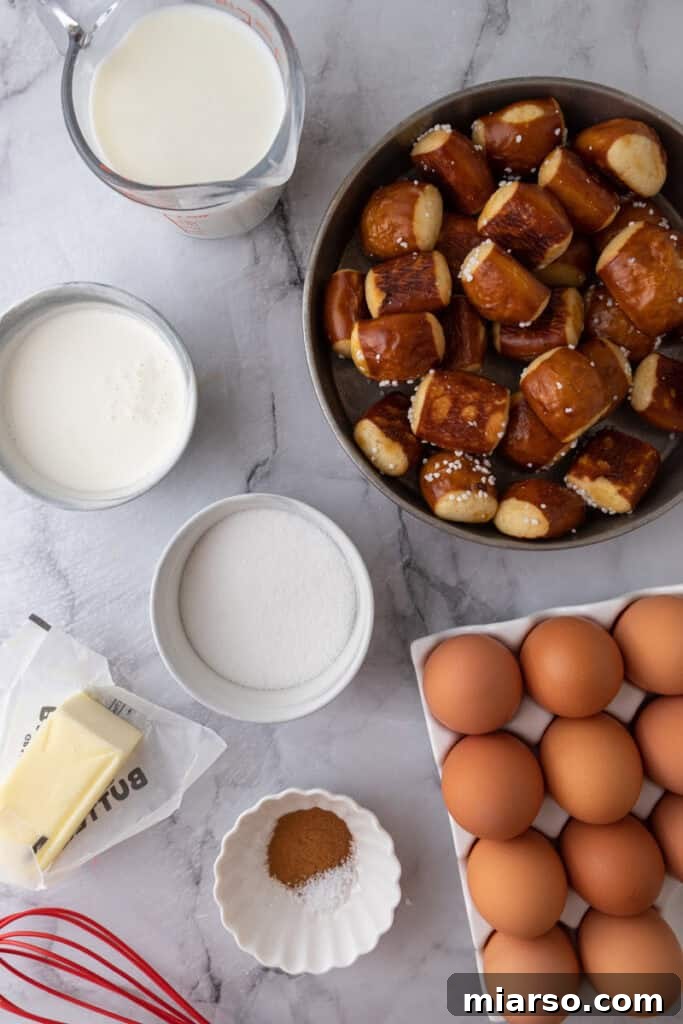 A high-angle shot showcasing all the fresh, high-quality ingredients required for the Pretzel French Toast Bake recipe, neatly laid out on a clean countertop, ready for preparation.