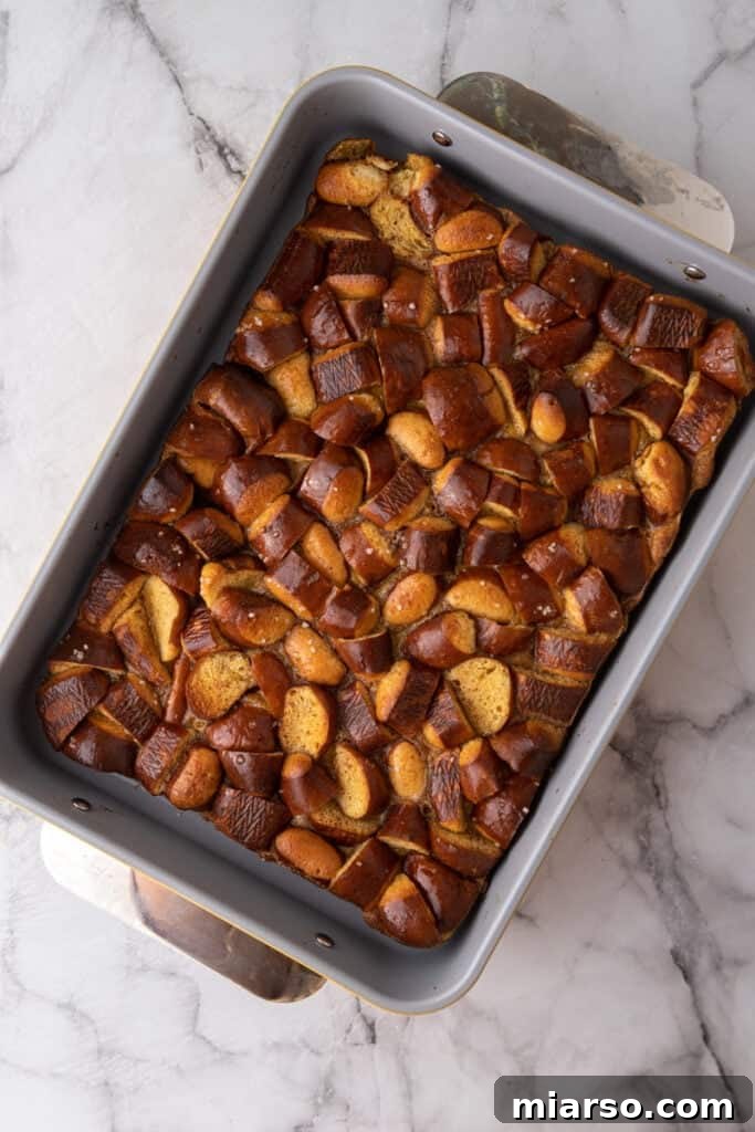 The Pretzel French Toast Bake freshly emerged from the oven, showcasing a perfectly golden-brown, inviting crust and bubbling custard.