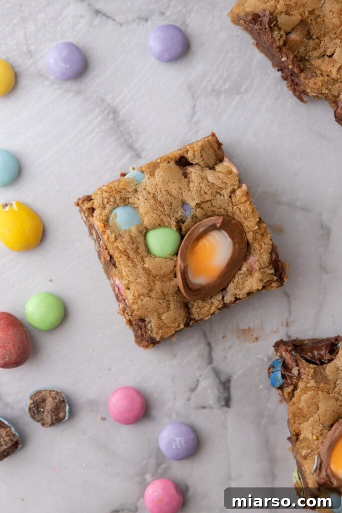 A single Cadbury Egg Chocolate Chip Easter Cookie Bar showcasing its vibrant mix-ins and chewy texture.
