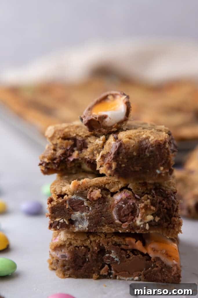 A side shot of a Cadbury Egg Chocolate Chip Easter Cookie Bar on a serving plate.