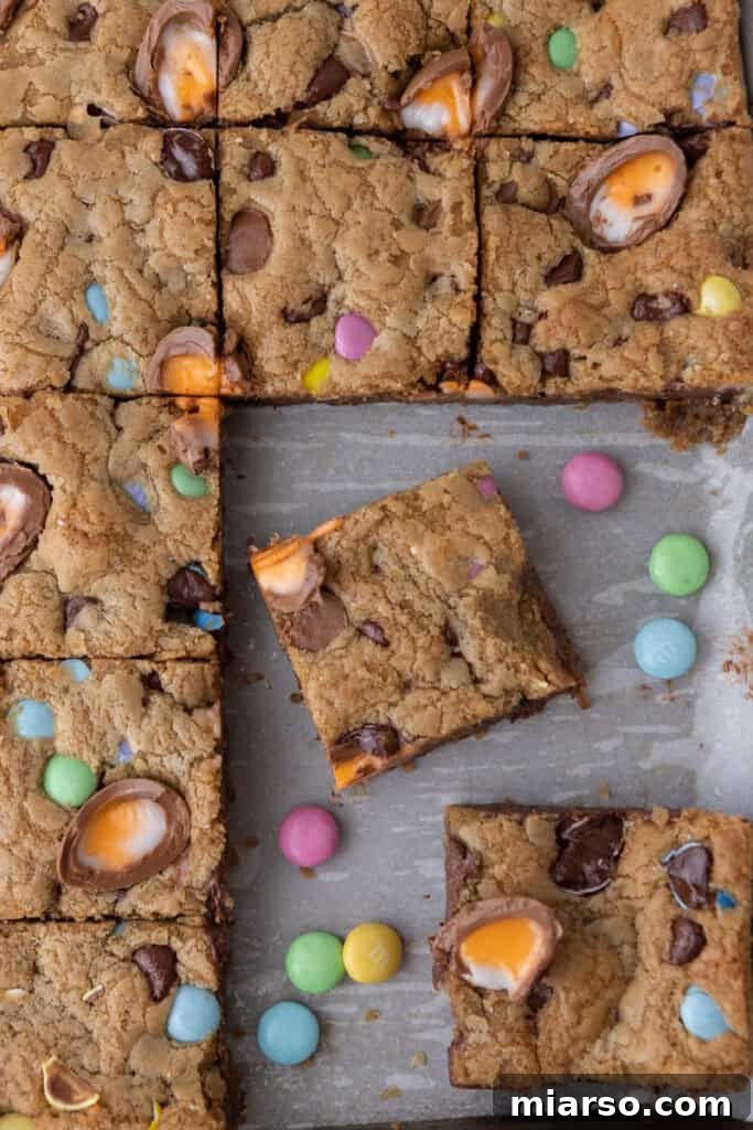 An overhead shot of several cut Cadbury Egg Chocolate Chip Easter Cookie Bars.