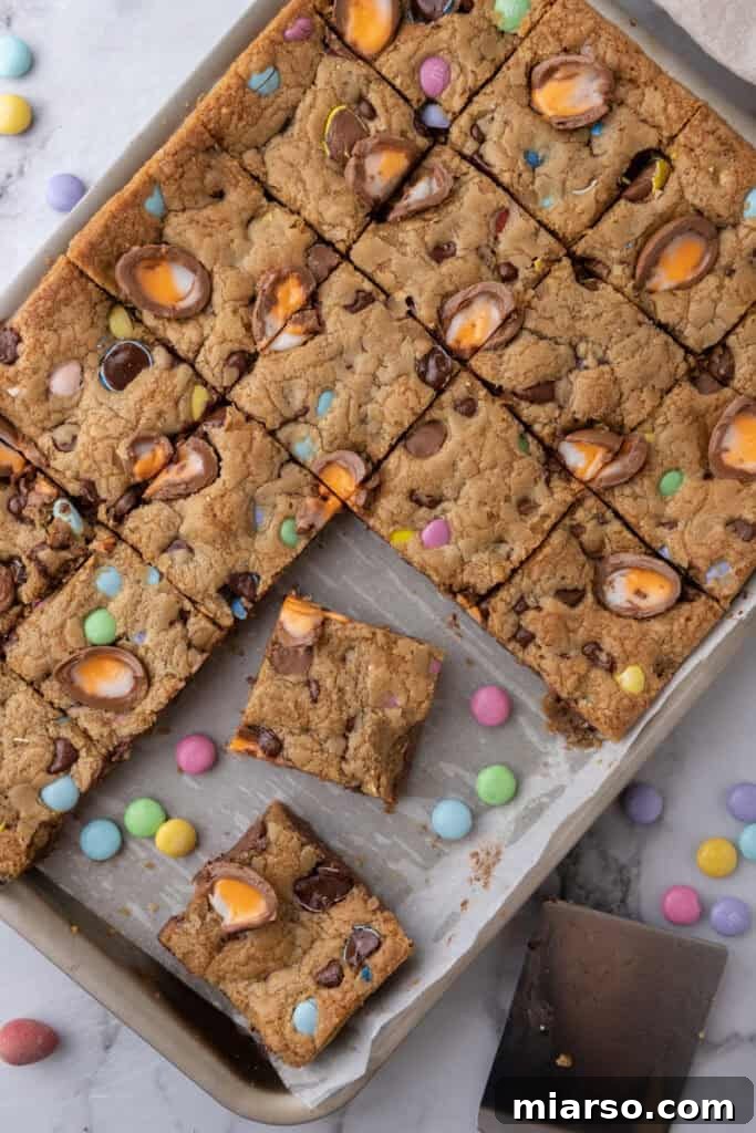 An overhead shot of a pile of Cadbury Egg Chocolate Chip Easter Cookie Bars.