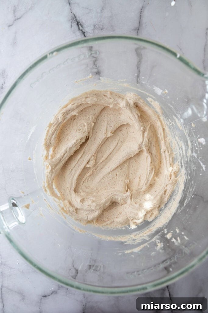 Irresistible Brown Butter Frosting 8 whipped ingredients in a bowl