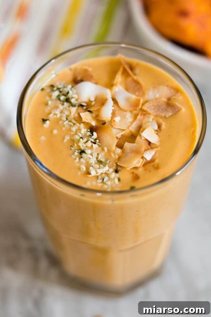 Sweet potato smoothie topped with hemp seeds and toasted coconut flakes