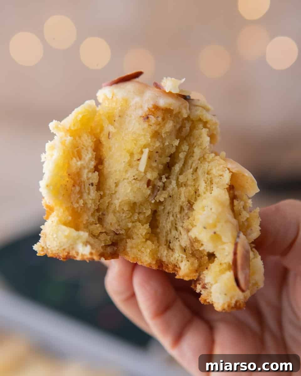 Irresistible Almond Croissant Cinnamon Rolls: Bakery-Soft and Buttery 2 Almond croissant cinnamon rolls baked until golden brown with toasted slivered almonds and almond glaze