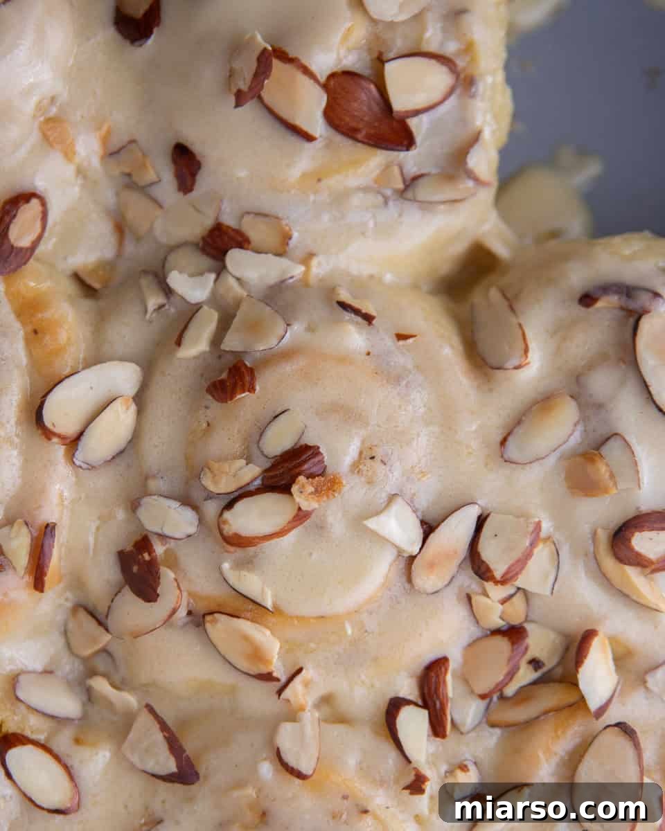 Irresistible Almond Croissant Cinnamon Rolls: Bakery-Soft and Buttery 18 Almond glaze drizzled over warm cinnamon rolls