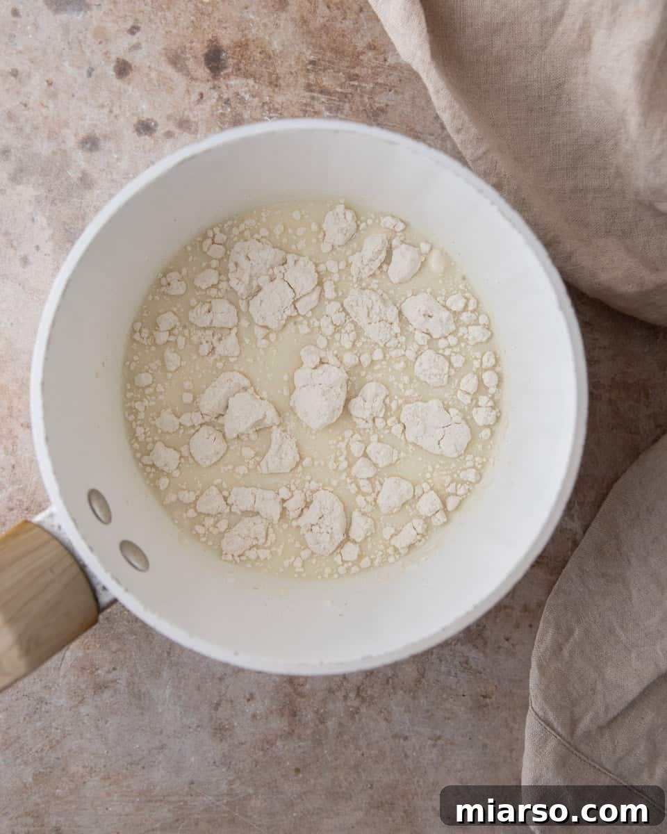 Irresistible Almond Croissant Cinnamon Rolls: Bakery-Soft and Buttery 6 Tangzhong ingredients in a sauce pan before cooking.