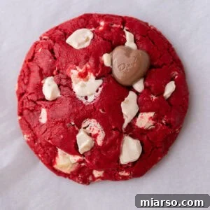 Single serve red velvet cookie with white chocolate chunks and a glossy cracked top