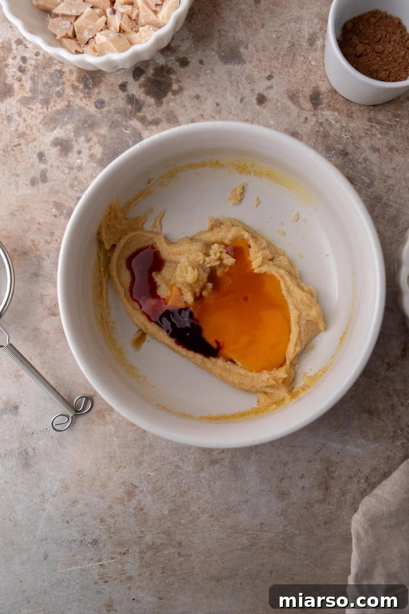 Egg yolk and vanilla extract added to cookie dough mixture