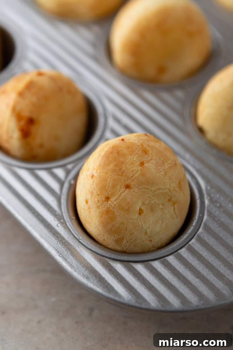 Mini muffin cups, filled halfway with the rich Brazilian cheese bread batter, gleaming and ready to bake and puff beautifully in the hot oven.