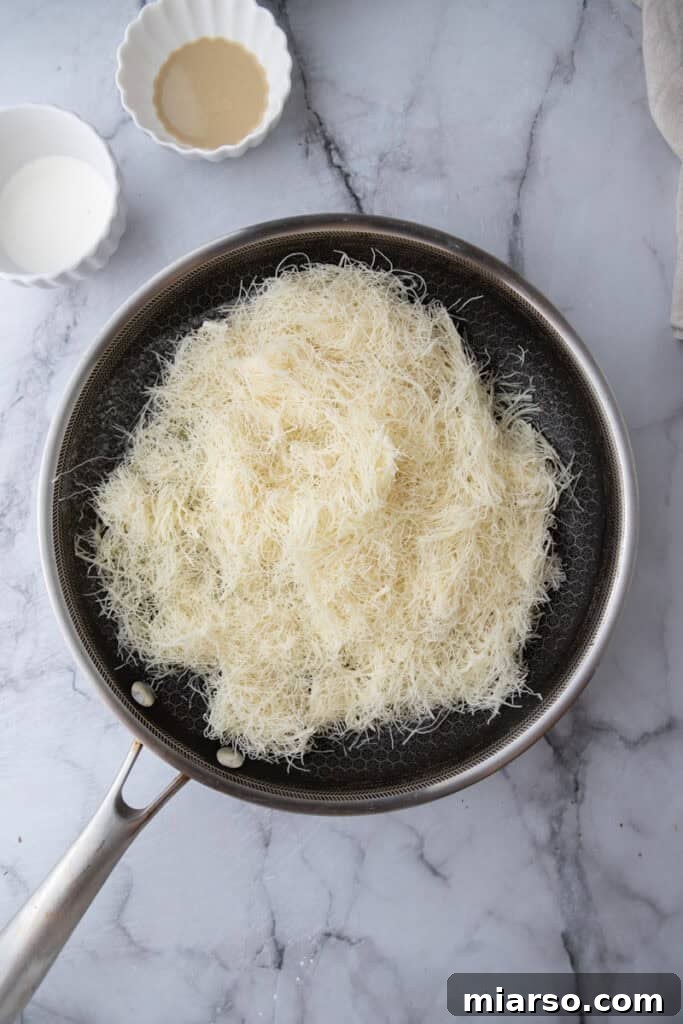 Dubai's Viral Pistachio Kunafa Brownies 14 kataifi dough in a pan, before toasting