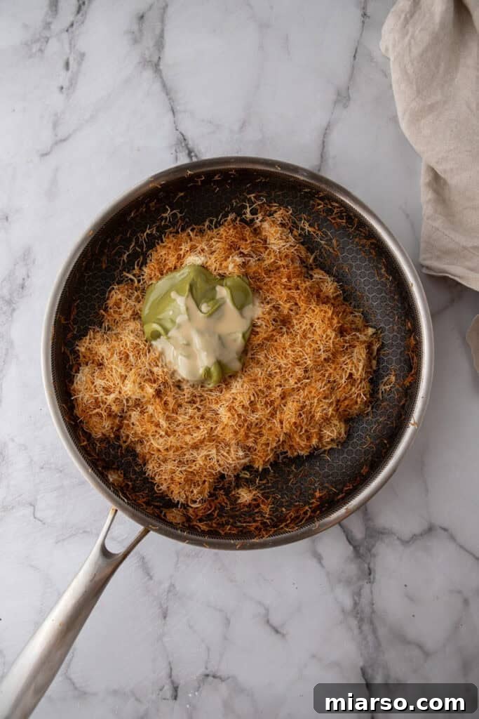 Dubai's Viral Pistachio Kunafa Brownies 15 ingredients in a pan, showing toasted kataifi